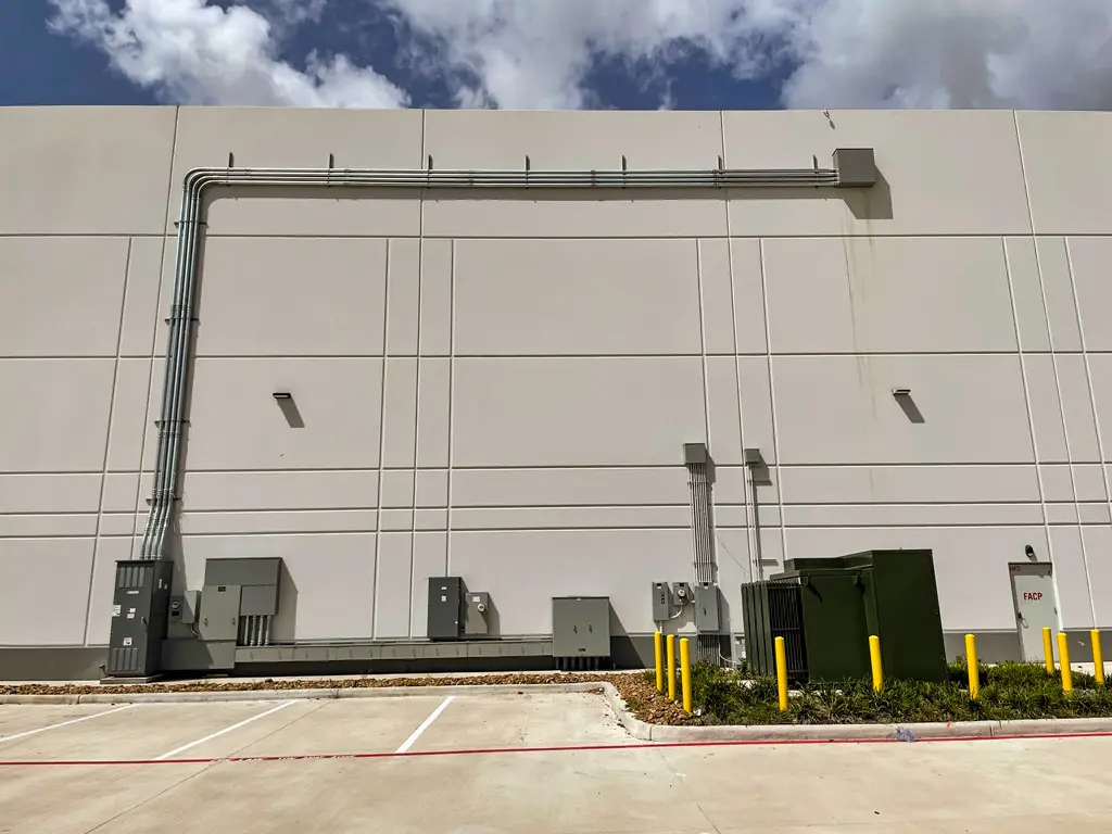 Electrical equipment on a building's exterior wall.