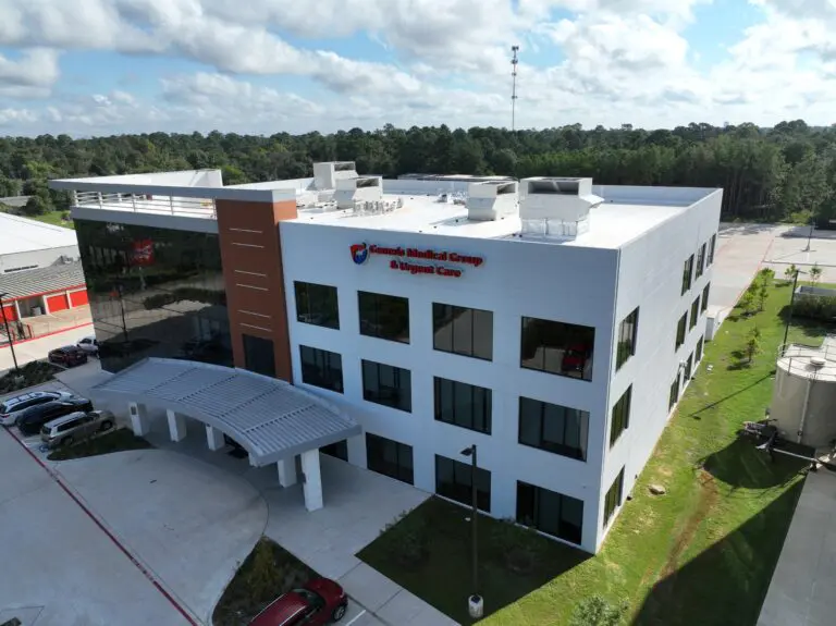 Medical building with sign and parking area.