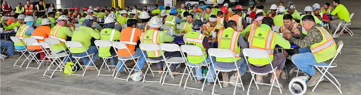 Workers attending a meeting in large group.