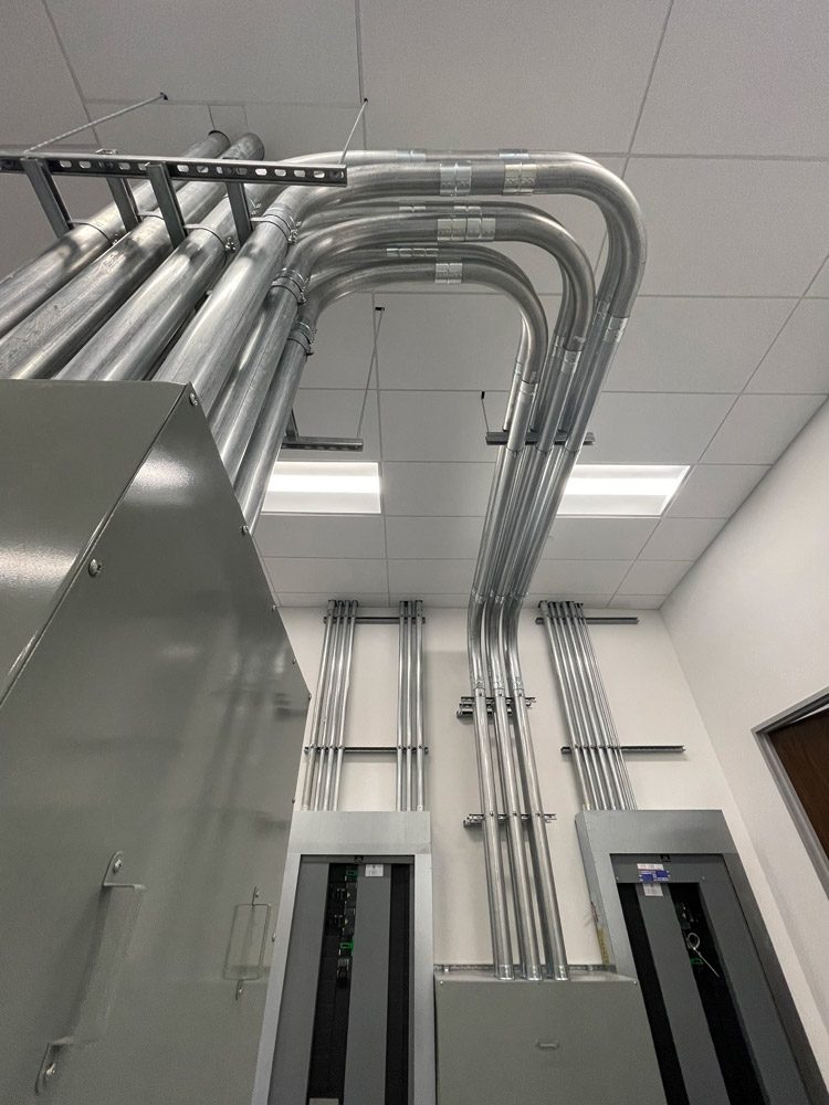 Electrical conduits and panels in building.
