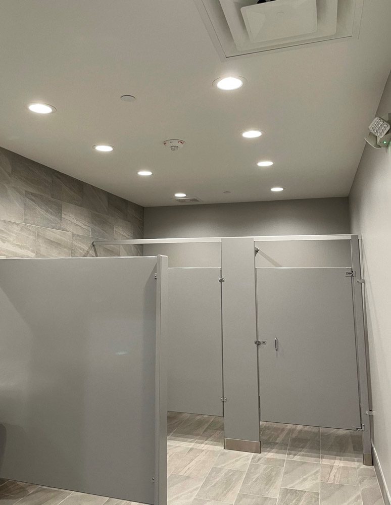 Modern restroom interior with gray partitions.