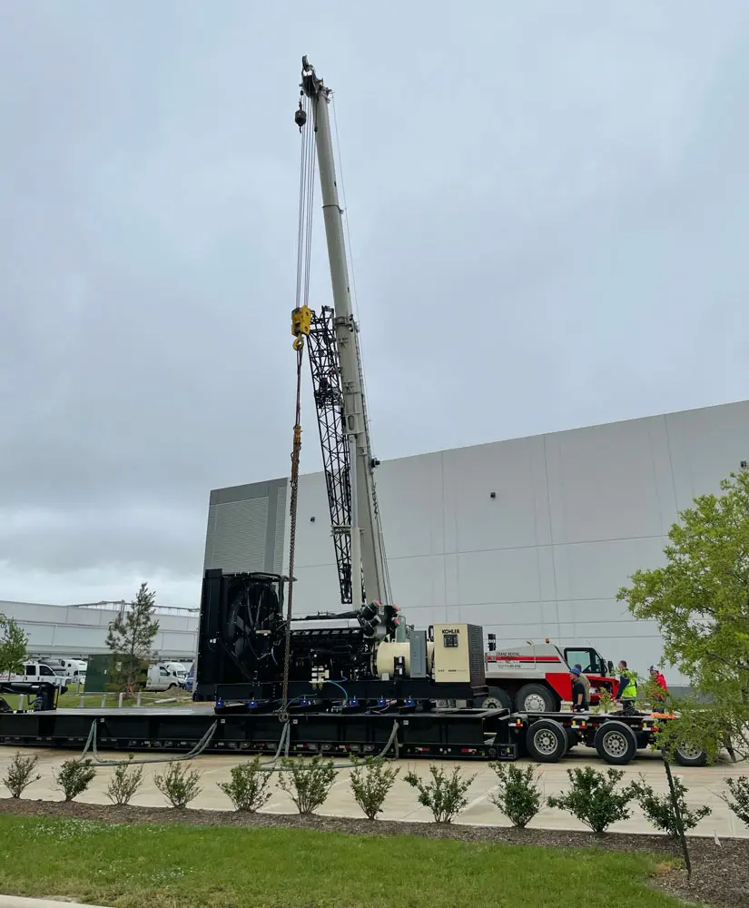 Heavy crane operating near a building site.