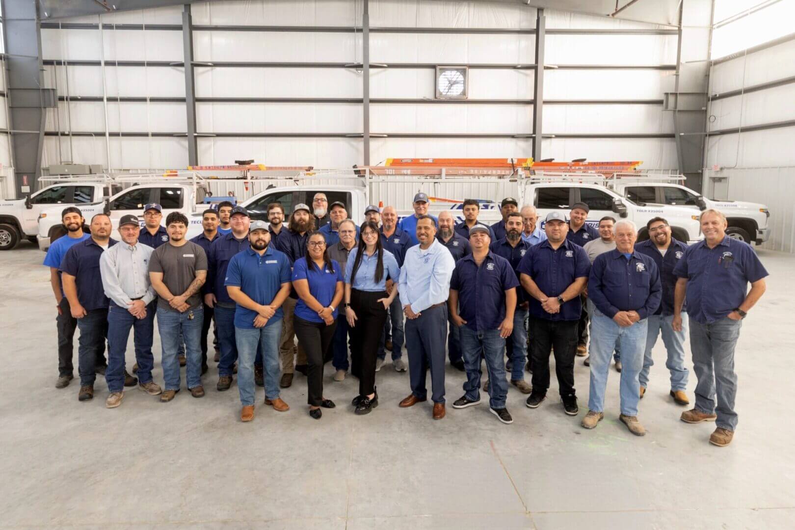 Group of workers posing in a warehouse.