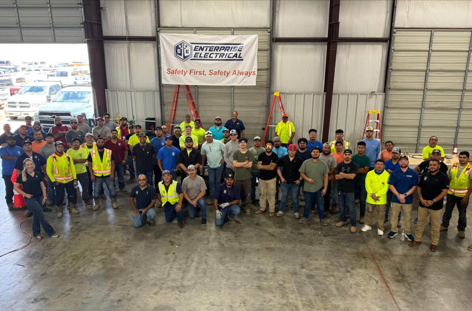 Electricians gathered for a safety stand-down meeting discussing workplace safety procedures
